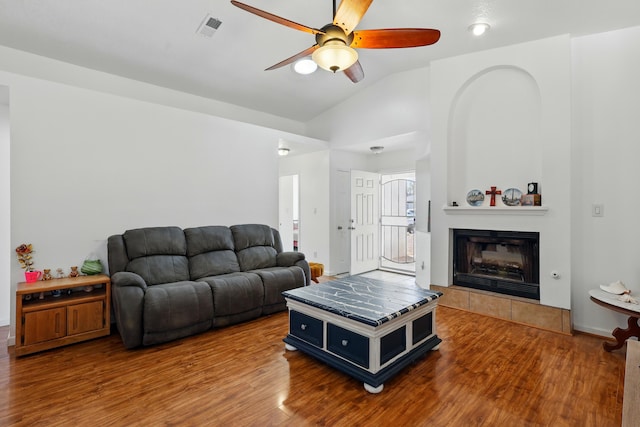 6901 Verano Ct NW, Albuquerque, NM 87120 - living room featuring a ceiling fan, lofted ceiling, wood finished floors, and a tiled fireplace
