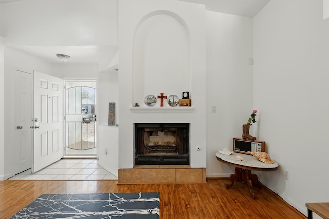 6901 Verano Ct NW, Albuquerque, NM 87120 - living room with wood finished floors, a tiled fireplace, and baseboards