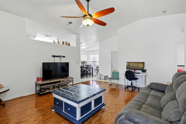 6901 Verano Ct NW, Albuquerque, NM 87120 - living room featuring vaulted ceiling, a ceiling fan, wood finished floors, and baseboards
