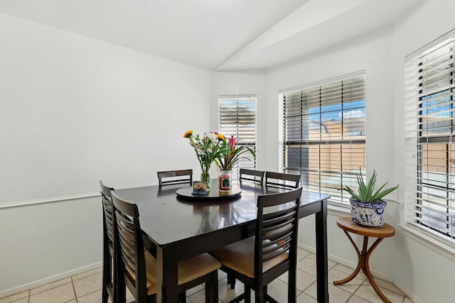 6901 Verano Ct NW, Albuquerque, NM 87120 - dining room with lofted ceiling, light tile patterned floors, and baseboards