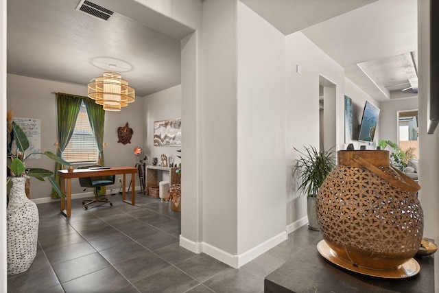 hall featuring baseboards, visible vents, and a wealth of natural light