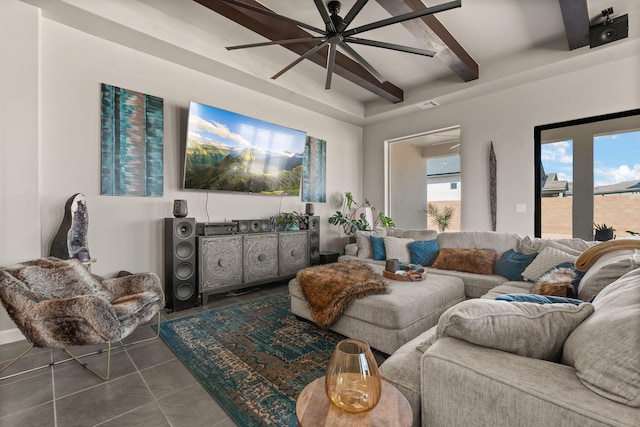 living area with beamed ceiling, dark tile patterned floors, ceiling fan, and visible vents
