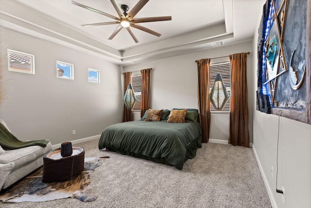 bedroom featuring baseboards, a tray ceiling, and carpet floors