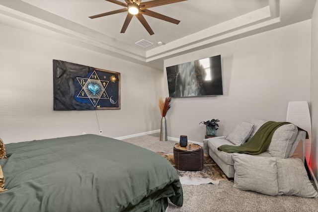 bedroom featuring baseboards, visible vents, a ceiling fan, carpet floors, and a raised ceiling