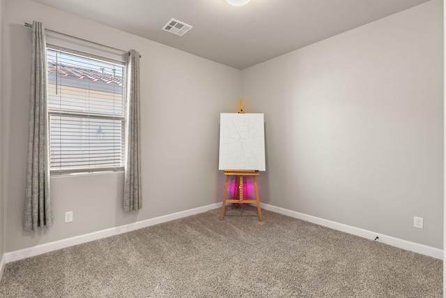 carpeted empty room with baseboards and visible vents