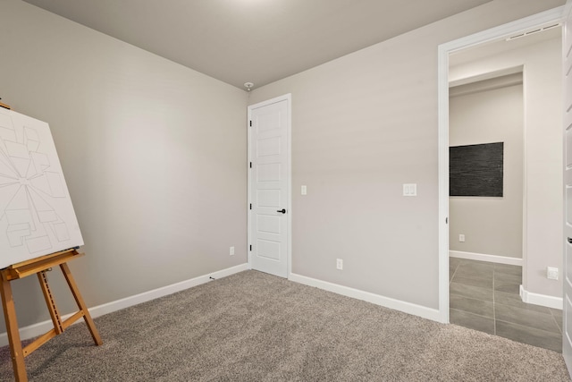 unfurnished bedroom featuring carpet and baseboards
