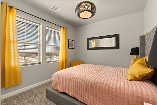 carpeted bedroom with baseboards and visible vents
