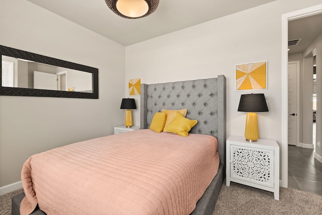 bedroom featuring carpet floors, visible vents, and baseboards