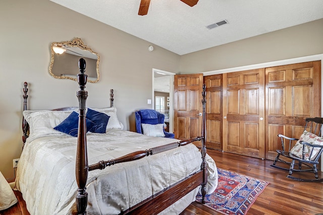 bedroom featuring ceiling fan, a textured ceiling, visible vents, wood finished floors, and a closet