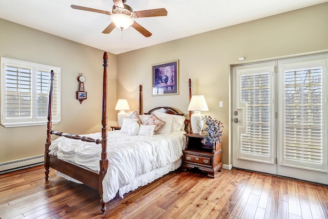 bedroom with access to outside, a baseboard radiator, ceiling fan, and hardwood / wood-style flooring