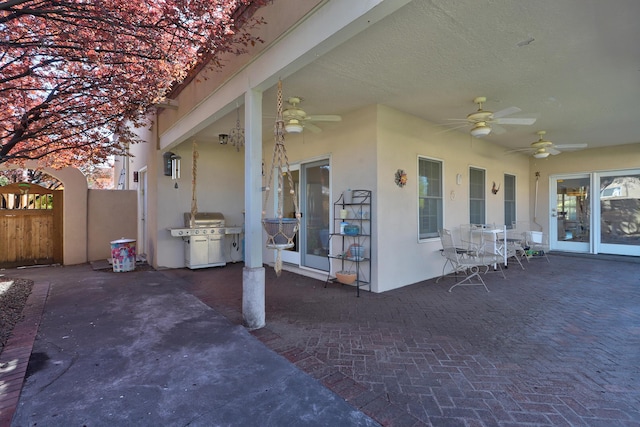 view of patio / terrace with ceiling fan, fence, and grilling area