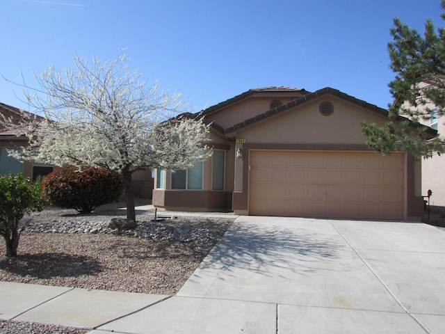 2843 Violeta Cir SE, Rio Rancho, NM 87124 - single story home featuring a tile roof, an attached garage, concrete driveway, and stucco siding