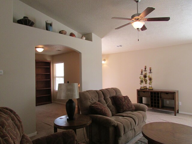 2843 Violeta Cir SE, Rio Rancho, NM 87124 - living area with light carpet, arched walkways, a textured ceiling, visible vents, and ceiling fan