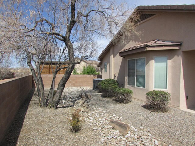 2843 Violeta Cir SE, Rio Rancho, NM 87124 - view of property exterior with central AC, a fenced backyard, and stucco siding