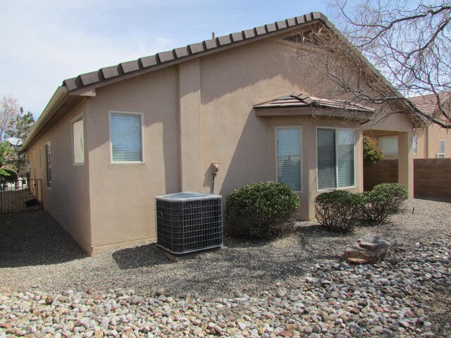 2843 Violeta Cir SE, Rio Rancho, NM 87124 - rear view of property with fence, central air condition unit, and stucco siding