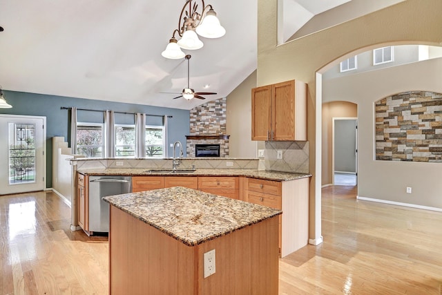 2703 Pueblo Grande Trl NW, Albuquerque, NM 87120 - kitchen with a sink, a fireplace, backsplash, a peninsula, and dishwasher