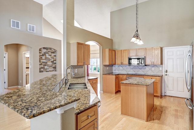 2703 Pueblo Grande Trl NW, Albuquerque, NM 87120 - kitchen featuring high vaulted ceiling, stainless steel appliances, arched walkways, and a sink