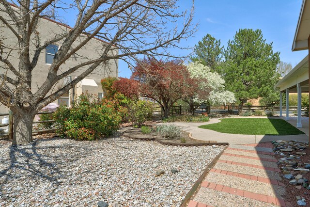 2703 Pueblo Grande Trl NW, Albuquerque, NM 87120 - view of yard featuring fence and a patio area