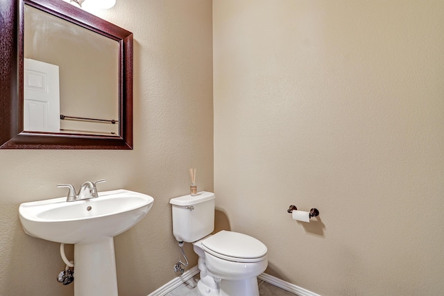 2703 Pueblo Grande Trl NW, Albuquerque, NM 87120 - half bathroom with a sink, toilet, and baseboards