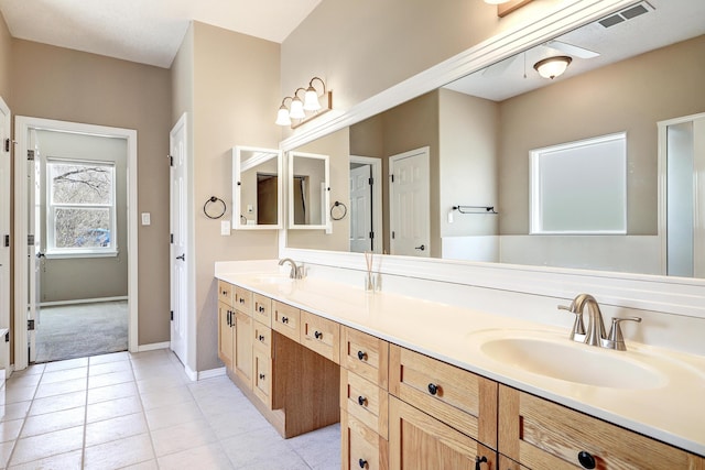 2703 Pueblo Grande Trl NW, Albuquerque, NM 87120 - bathroom with a sink, double vanity, visible vents, baseboards, and tile patterned flooring