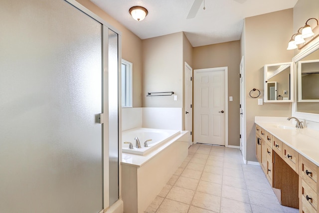 2703 Pueblo Grande Trl NW, Albuquerque, NM 87120 - bathroom with ceiling fan, vanity, baseboards, a stall shower, and a garden tub