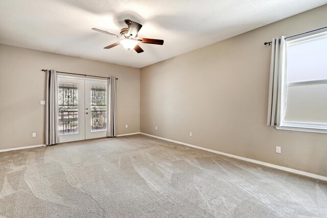 2703 Pueblo Grande Trl NW, Albuquerque, NM 87120 - spare room with carpet, french doors, a ceiling fan, and baseboards