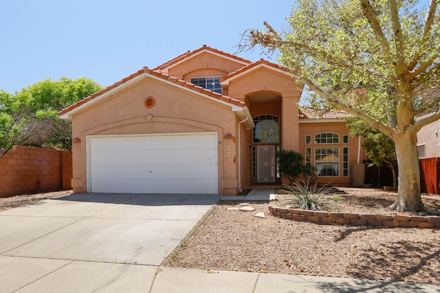 4804 Mesa Terraza Pl NW, Albuquerque, NM 87120 - mediterranean / spanish home with a tile roof, stucco siding, a garage, and driveway