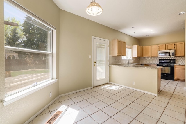 4804 Mesa Terraza Pl NW, Albuquerque, NM 87120 - kitchen featuring black electric range, stainless steel microwave, backsplash, light tile patterned floors, and recessed lighting