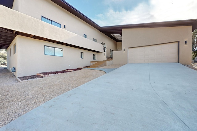 4500 Skyline Ct NE, Albuquerque, NM 87111 - view of side of property with concrete driveway and stucco siding