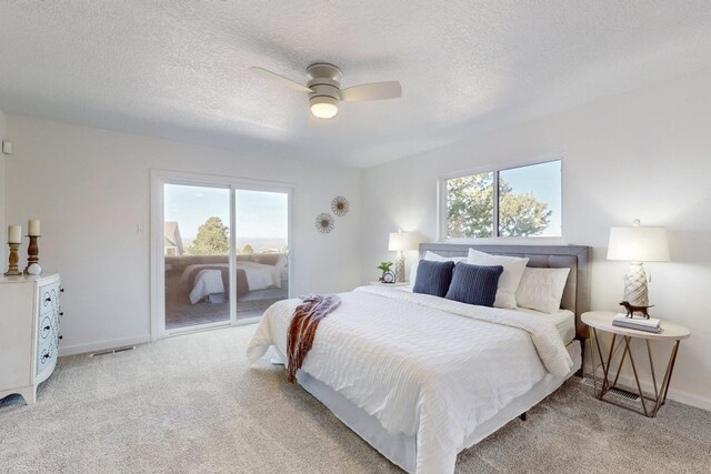 4500 Skyline Ct NE, Albuquerque, NM 87111 - bedroom featuring access to outside, carpet floors, a textured ceiling, and ceiling fan