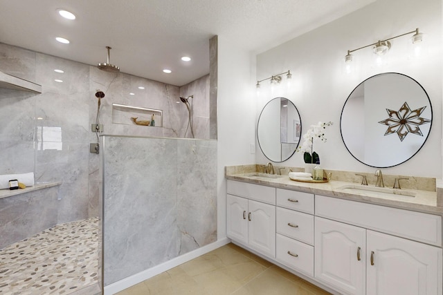 4500 Skyline Ct NE, Albuquerque, NM 87111 - bathroom with a tile shower, double vanity, and recessed lighting