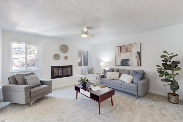 4500 Skyline Ct NE, Albuquerque, NM 87111 - living room with light carpet, a textured ceiling, ceiling fan, and a glass covered fireplace