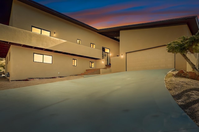 4500 Skyline Ct NE, Albuquerque, NM 87111 - view of front of house with stucco siding, driveway, and a garage