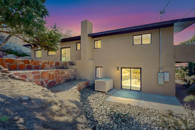 4500 Skyline Ct NE, Albuquerque, NM 87111 - rear view of house with stucco siding, a patio, and a chimney