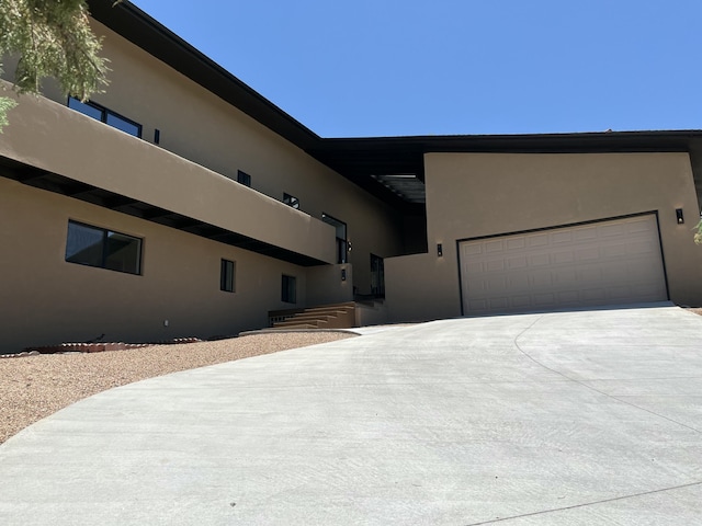 4500 Skyline Ct NE, Albuquerque, NM 87111 - view of front of house with stucco siding, concrete driveway, and an attached garage