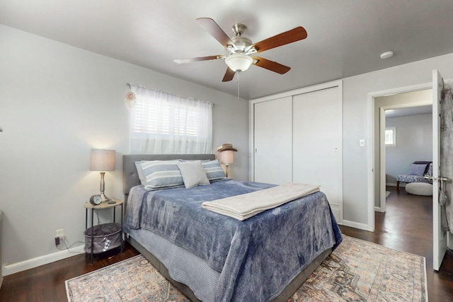 3501 Westerfeld Dr NE, Albuquerque, NM 87111 - bedroom featuring a closet, multiple windows, baseboards, and wood finished floors