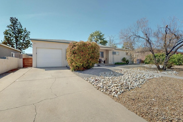 3501 Westerfeld Dr NE, Albuquerque, NM 87111 - ranch-style home with driveway, stucco siding, fence, and a garage