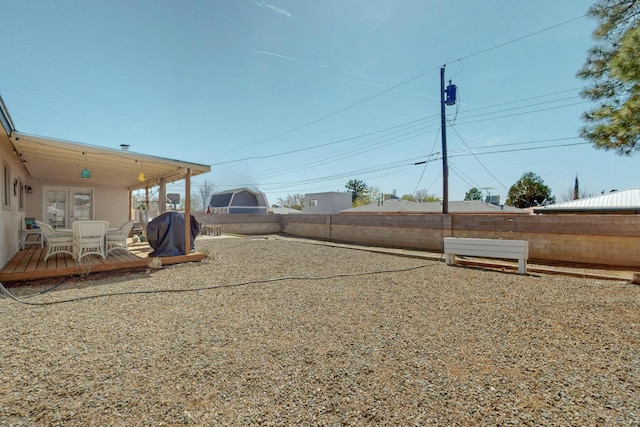 3501 Westerfeld Dr NE, Albuquerque, NM 87111 - view of yard featuring french doors, a fenced backyard, and a deck