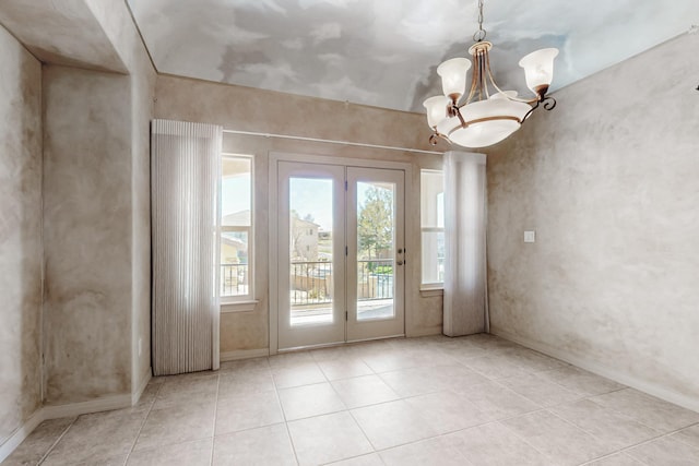 entryway featuring a chandelier, tile patterned floors, french doors, and baseboards