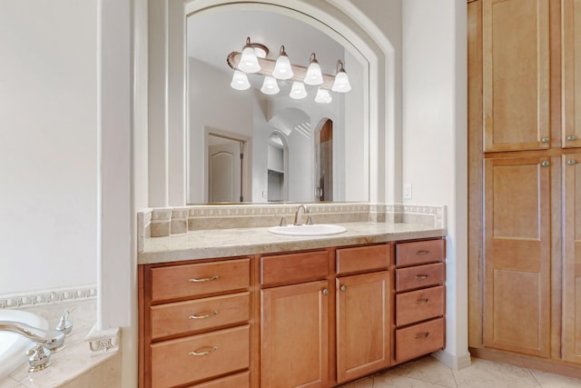 full bath with vanity and a garden tub