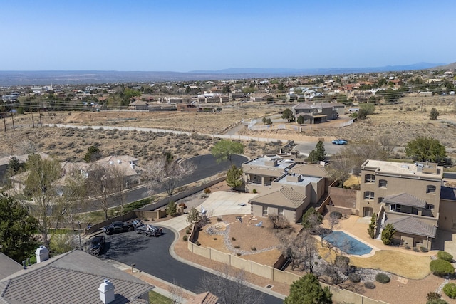 drone / aerial view featuring a residential view and a mountain view