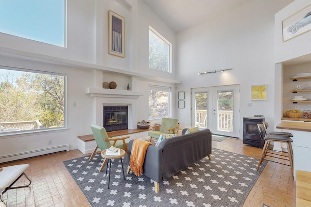 2 Cedar Hill Pl, Cedar Crest, NM 87008 - living area featuring a high ceiling, a baseboard radiator, brick flooring, a glass covered fireplace, and french doors