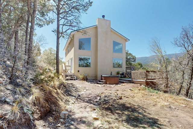 2 Cedar Hill Pl, Cedar Crest, NM 87008 - back of property featuring stucco siding, a hot tub, a chimney, and a deck with mountain view