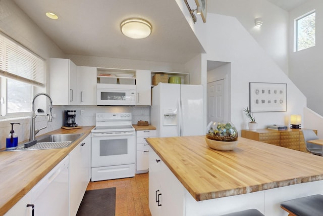 2 Cedar Hill Pl, Cedar Crest, NM 87008 - kitchen with white appliances, wood counters, open shelves, a breakfast bar, and backsplash