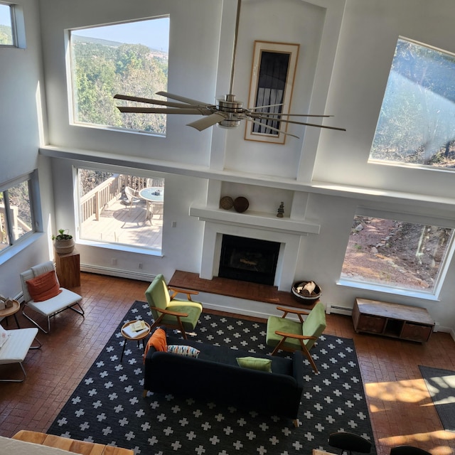 2 Cedar Hill Pl, Cedar Crest, NM 87008 - living room featuring hardwood / wood-style flooring, a fireplace with raised hearth, and healthy amount of natural light