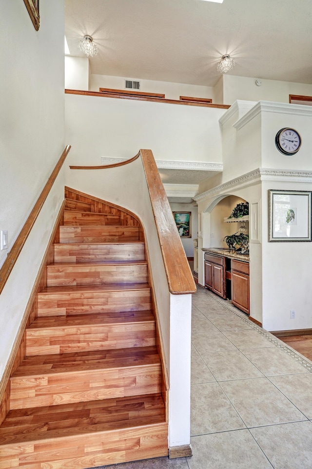 8300 R C Gorman Ave NE, Albuquerque, NM 87122 - staircase with tile patterned floors and a high ceiling
