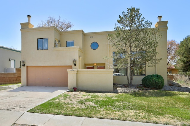 view of front of property featuring a garage, a chimney, fence, stucco siding, and driveway