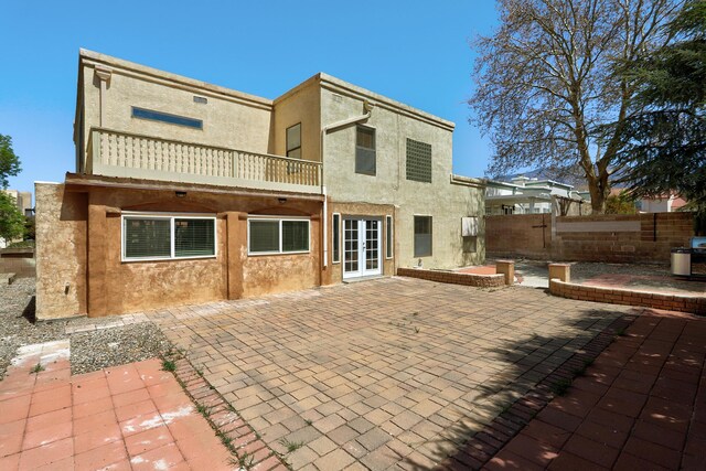8300 R C Gorman Ave NE, Albuquerque, NM 87122 - back of property with a balcony, stucco siding, a patio area, and french doors