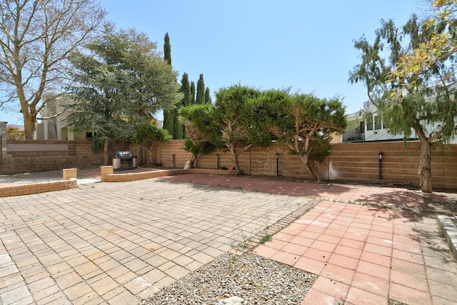 8300 R C Gorman Ave NE, Albuquerque, NM 87122 - fenced backyard featuring a patio and grilling area