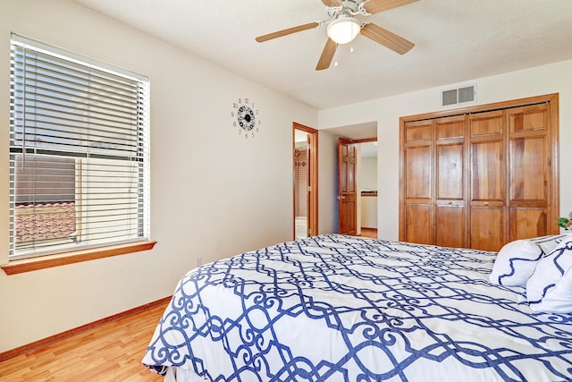 8300 R C Gorman Ave NE, Albuquerque, NM 87122 - bedroom with wood finished floors, a closet, and ceiling fan